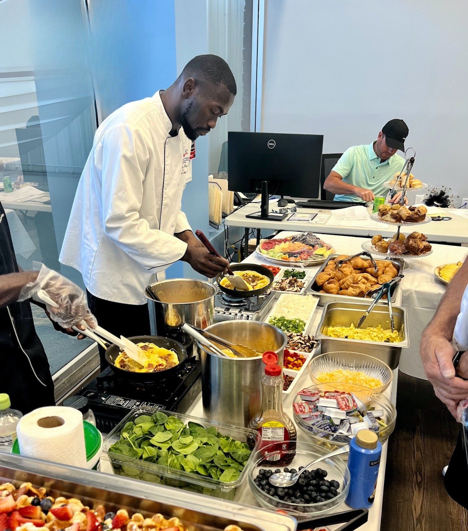 Chef Ricardo Lory preparing gourmet dishes for a corporate catering event in Naples, Florida.