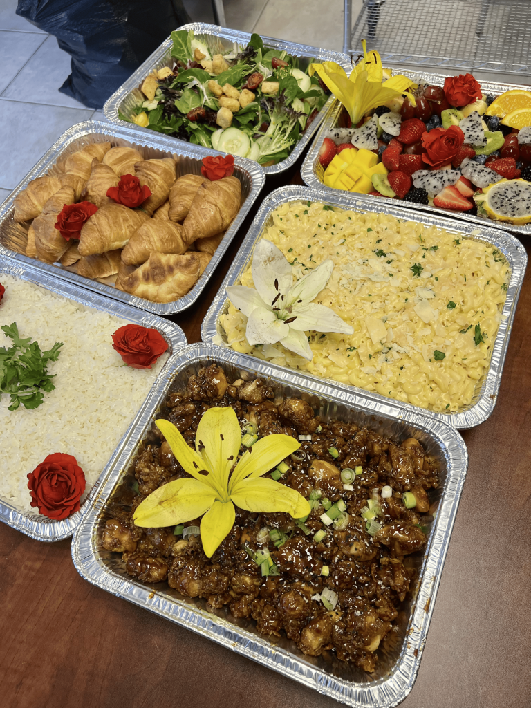 Chef Ricardo Lory presenting a custom catering tasting menu featuring international dishes at a Creative Catering Naples event.