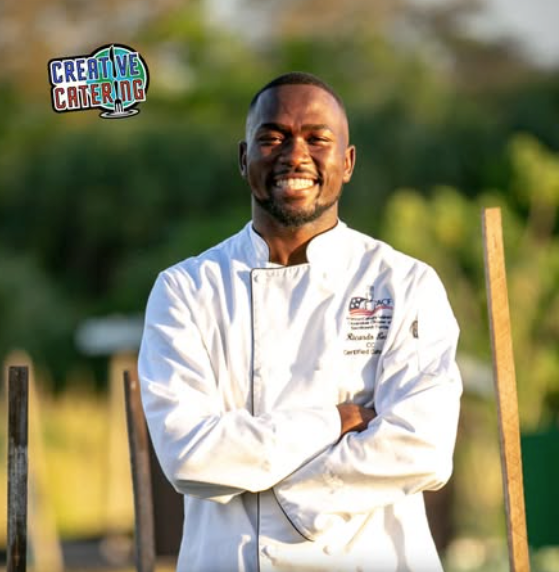 Chef Ricardo Lory, known as Chef Global, smiling in the kitchen while preparing globally inspired cuisine.