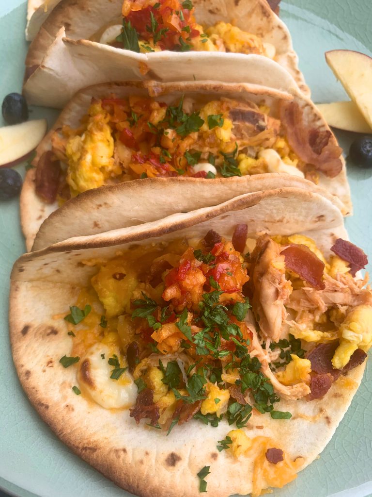 Chef Global presenting a colorful taco plate with fresh ingredients for Creative Catering Naples’ Mexican Collection.