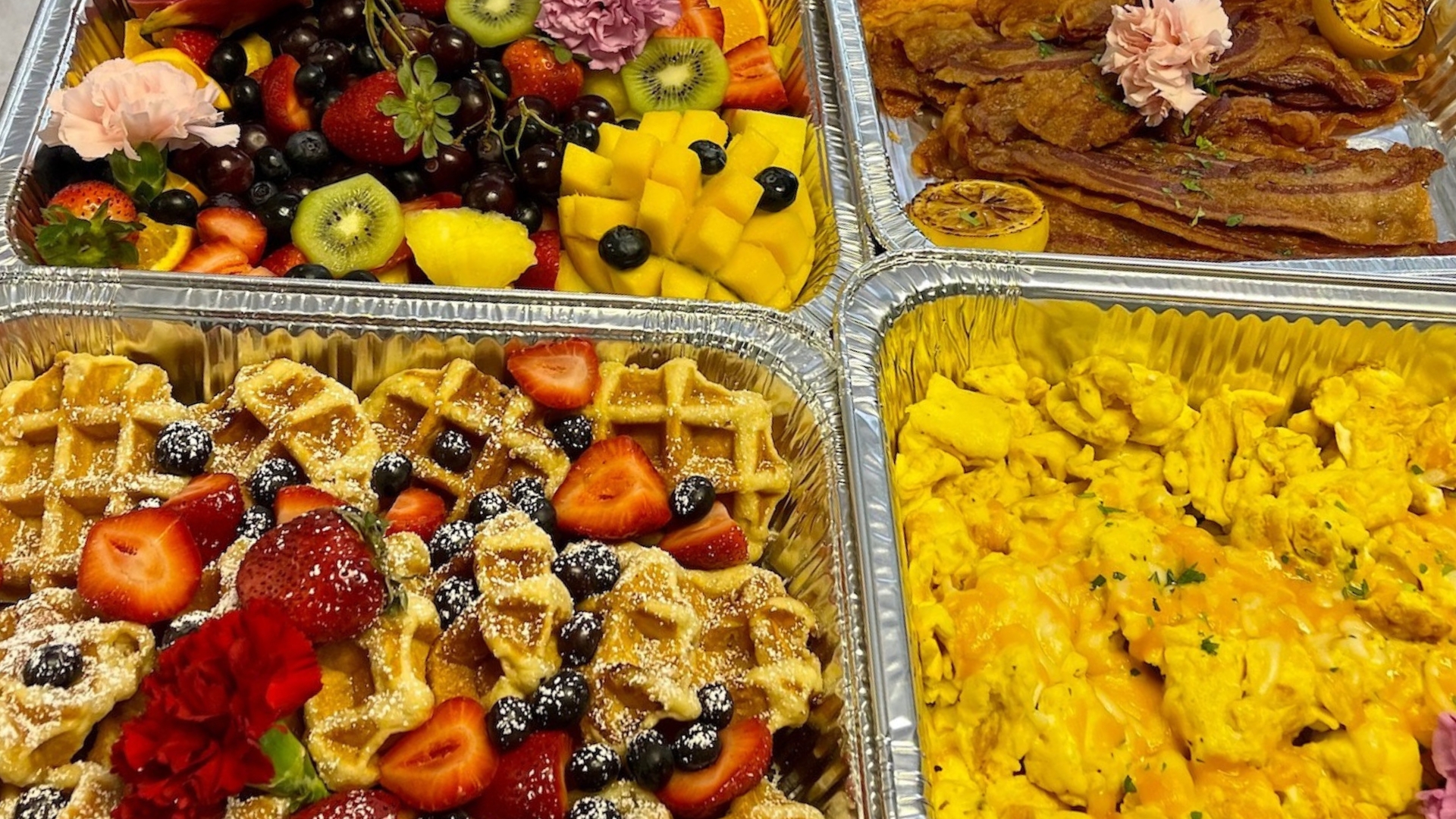 Gourmet brunch buffet setup by Creative Catering Naples with chef-prepared dishes, fresh pastries, and mimosa bar at a waterfront event in Naples, FL.