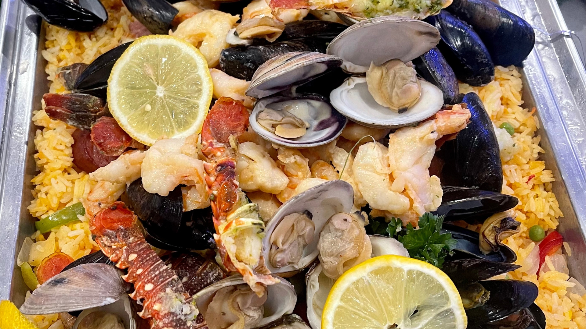 Vibrant plated dish featuring citrus-glazed seafood at a luxury Naples catering event