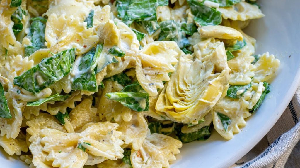 Chef Global preparing a gourmet pasta dish with fresh ingredients for Creative Catering Naples’ Italian Collection.