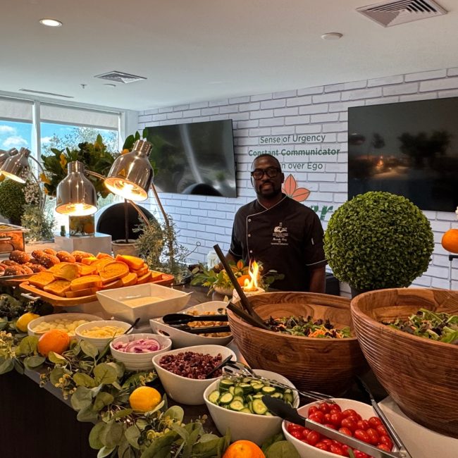 Elegant outdoor wedding reception catered by Creative Catering Naples with white linen tables, plated gourmet dishes, and oceanfront sunset in Naples, Florida.