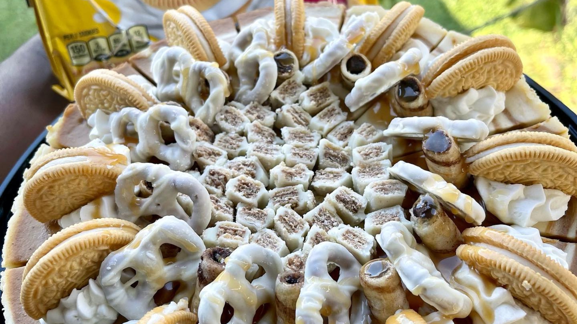 Luxury dessert table at a Naples waterfront wedding with assorted pastries, macarons, and tropical fruit tarts styled by Creative Catering Naples.