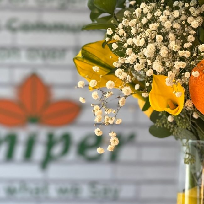 Elegant table setting with gourmet hors d'oeuvres, floral centerpieces, and champagne flutes, showcasing luxury event catering in Naples, Florida.