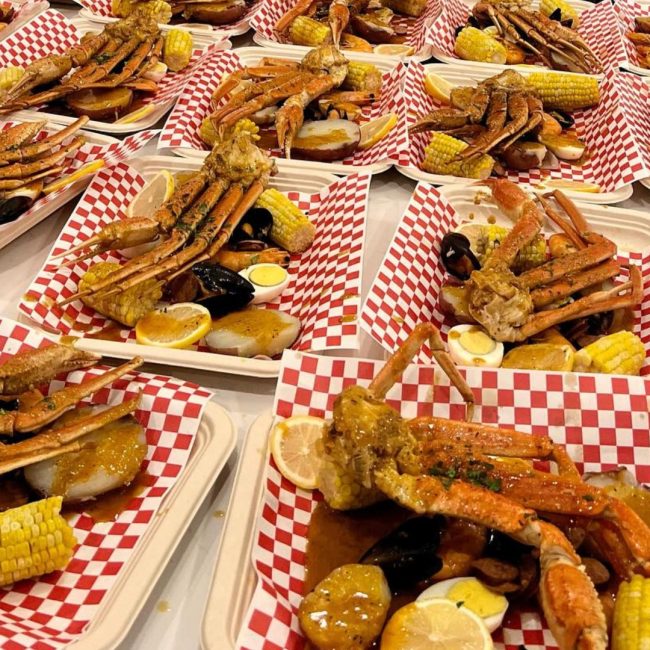 Elegant beach wedding reception setup with Creative Catering Naples signature dishes like seafood platters and carving stations, overlooking the Gulf of Mexico.