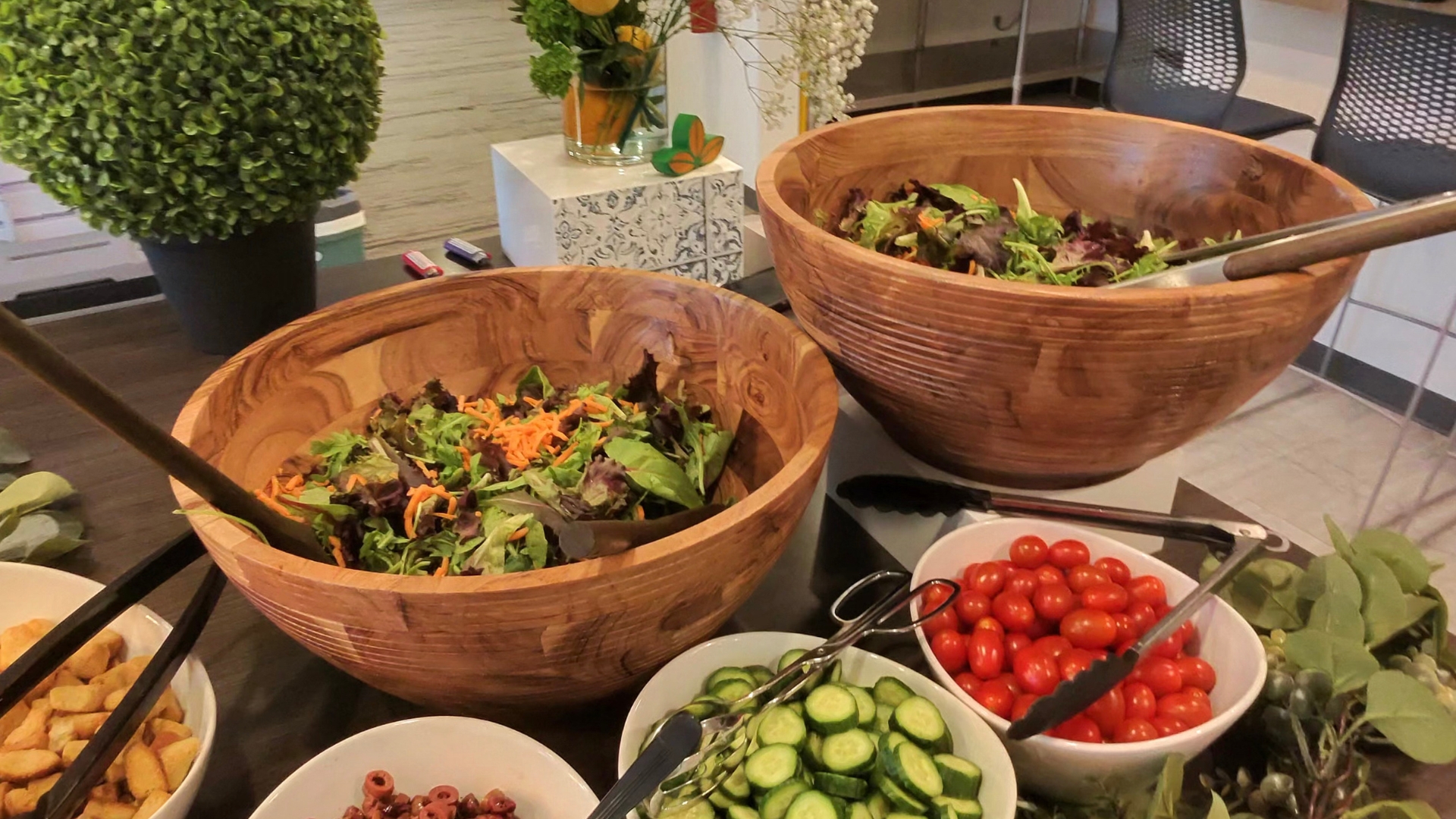 Chef plating colorful farm-to-table dishes sourced from a Naples, Florida farmers market at a luxury outdoor event.