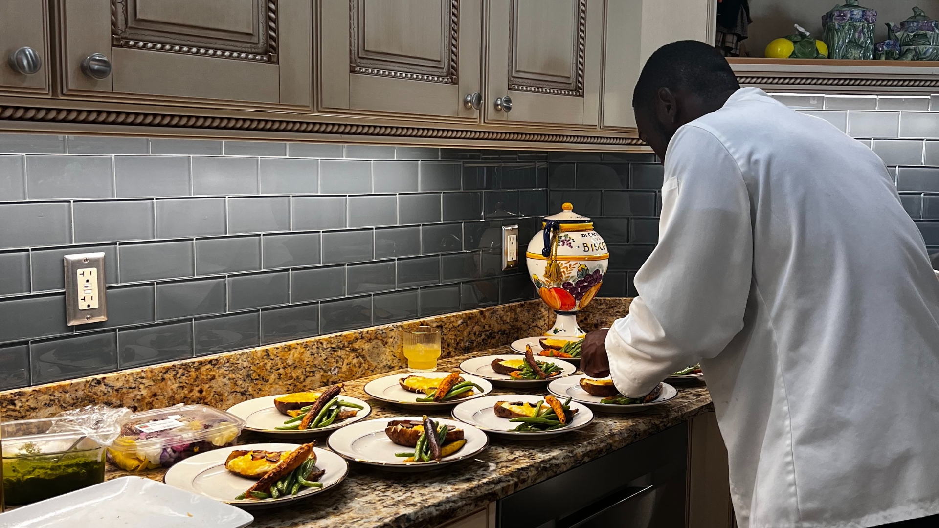 A private chef plating a gourmet dish in an elegant waterfront home in Naples, Florida, during a luxury VIP dinner experience.