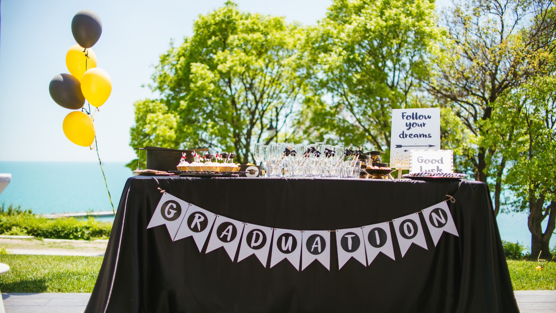 Graduation party catering Naples FL by Creative Catering Naples featuring luxury buffet display, graduation-themed dessert table, elegant outdoor setup, and gourmet catering presentation in Naples Florida.