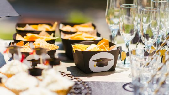 Luxury graduation catering Naples Florida by Creative Catering Naples featuring elegant buffet stations, gourmet appetizers, graduation cake display, and upscale outdoor celebration setup.