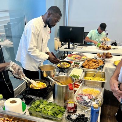 Chef Ricardo Lory preparing gourmet dishes for a corporate catering event in Naples, Florida.