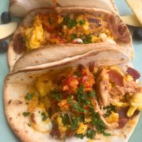 Chef Global presenting a colorful taco plate with fresh ingredients for Creative Catering Naples’ Mexican Collection.