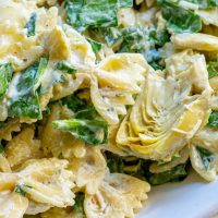 Chef Global preparing a gourmet pasta dish with fresh ingredients for Creative Catering Naples’ Italian Collection.