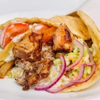 greek gyros stuffed with meat, salad, onion, tomato and potato
