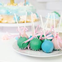 Green blue cake pops on the plate. Candy bar for birthday.