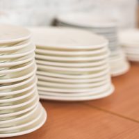 Selective focus of clean white plates on wooden surface
